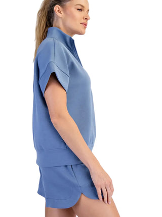 Woman wearing a blue outfit on a white background
