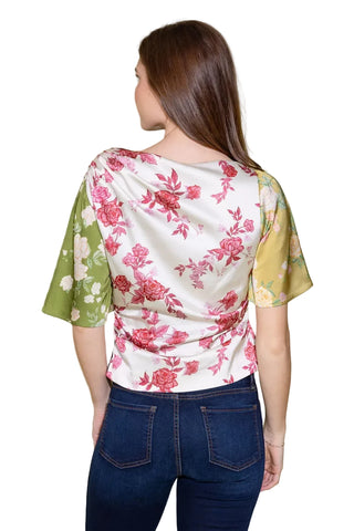Woman wearing a floral blouse with a plain background