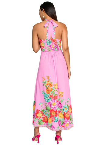 Woman wearing a pink floral dress on a white background