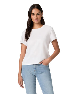 Woman wearing a white t-shirt and light blue jeans on a plain background