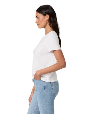 Woman wearing a white t-shirt and light blue jeans against a plain background