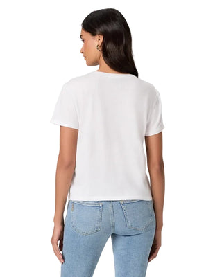 A woman shown from the back wearing a plain white short-sleeve crop top and light blue jeans against a light gray studio background.