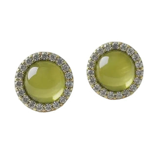 A pair of round stud earrings featuring large olive green cabochon centers surrounded by a halo of small clear stones in a gold setting, displayed on a light textured white background.
