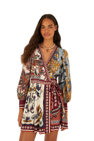 Woman wearing a patterned dress on a white background