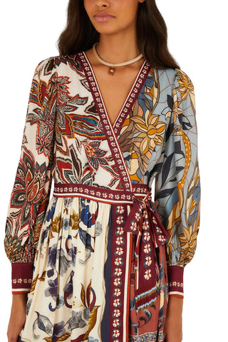 Woman wearing a patterned dress with a white background